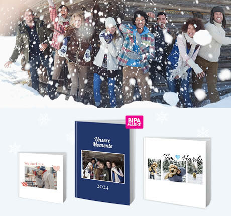 Gruppe im Schnee vor Holzhütte, daneben individuell gestaltete Fotobücher mit persönlichen Wintermomenten 2024.
